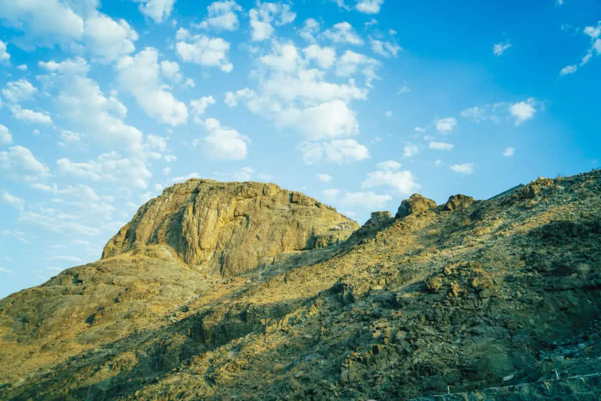 Jabal al-Nour, a rocky mountain in Makkah, under a blue sky with scattered clouds